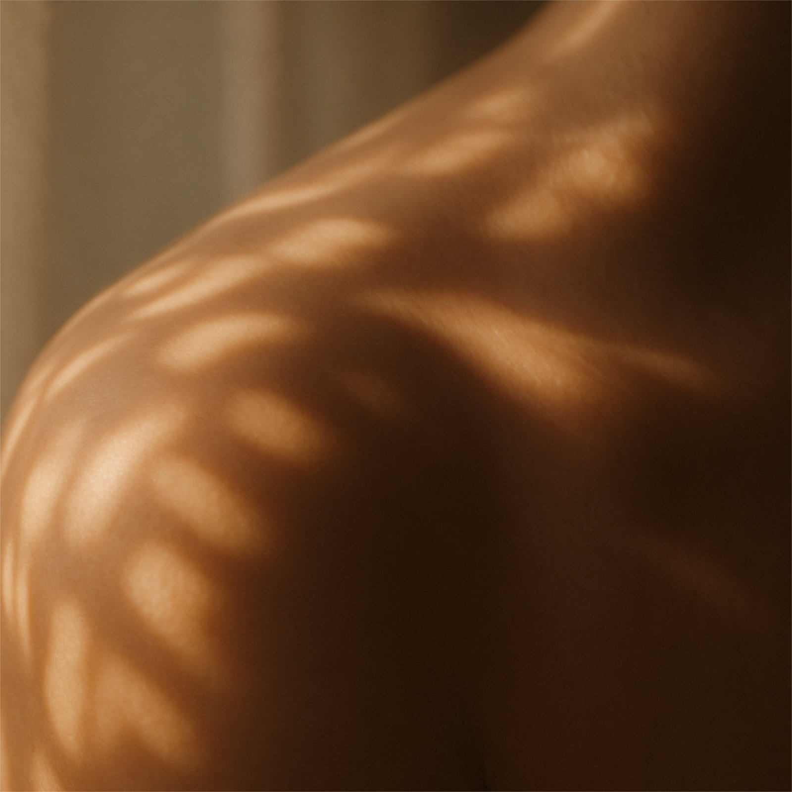 Close-up of softly lit skin in warm tones.